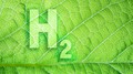 Ilustração mostra o símbolo do hidrogênio, H2, sobre um fundo verde