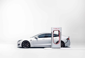 Carro elétrico da Tesla junto a uma estação de carregamento de baterias